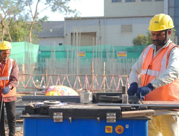 Workers at rebar station